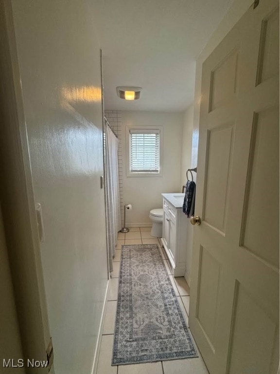 1505 N 14th St, Cambridge, OH 43725 - full bathroom with tile patterned flooring, toilet, vanity, and curtained shower