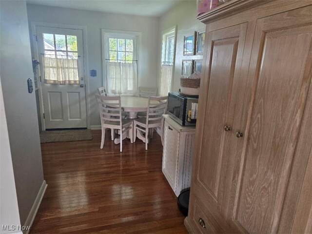 1505 N 14th St, Cambridge, OH 43725 - dining space with dark wood-type flooring and baseboards