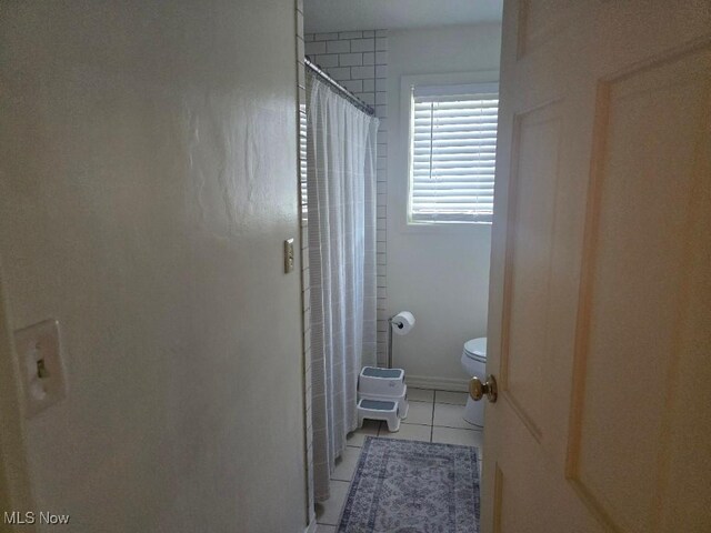1505 N 14th St, Cambridge, OH 43725 - full bath featuring tile patterned flooring, toilet, and a shower with curtain