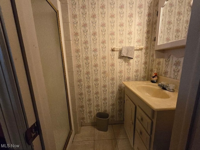 1505 N 14th St, Cambridge, OH 43725 - full bath featuring vanity, a shower stall, tile patterned flooring, wallpapered walls, and baseboards