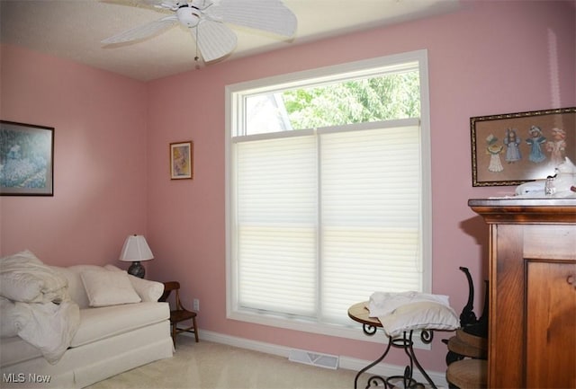7711 Marewood Pl, Painesville, OH 44077 - living area with light carpet, ceiling fan, and baseboards