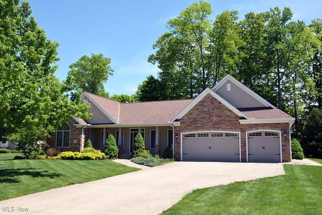 7711 Marewood Pl, Painesville, OH 44077 - view of front facade featuring a garage, concrete driveway, a front lawn, and stone siding