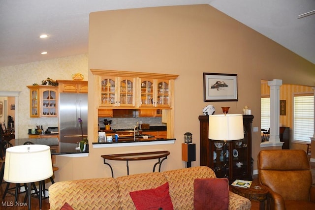 7711 Marewood Pl, Painesville, OH 44077 - dining space featuring ornate columns, recessed lighting, high vaulted ceiling, and dark wood-style floors