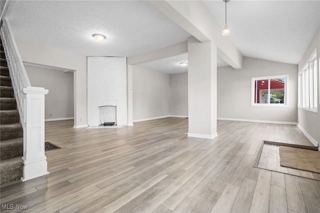 361 Para Ave, Akron, OH 44305 - unfurnished living room with stairs, light wood-type flooring, baseboards, a textured ceiling, and a fireplace
