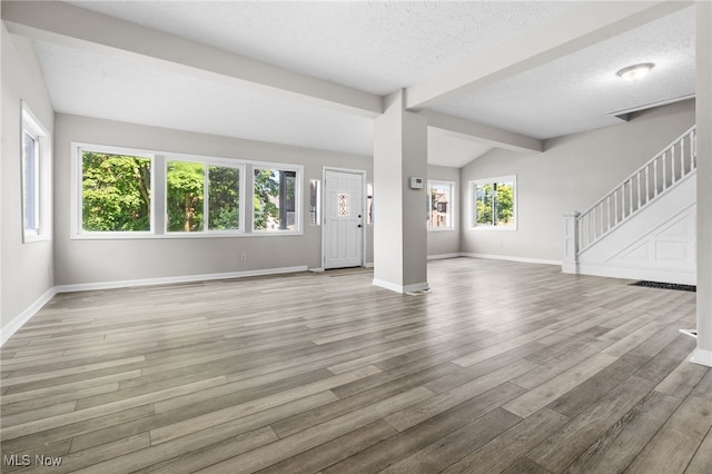 361 Para Ave, Akron, OH 44305 - unfurnished living room with wood finished floors, a textured ceiling, baseboards, and stairway