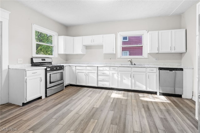 361 Para Ave, Akron, OH 44305 - kitchen featuring appliances with stainless steel finishes, light wood finished floors, white cabinetry, a sink, and light countertops