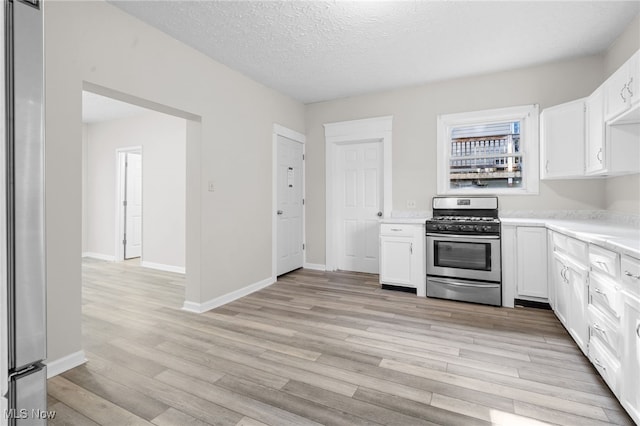 361 Para Ave, Akron, OH 44305 - kitchen with stainless steel appliances, light wood-style flooring, light countertops, white cabinetry, and a textured ceiling