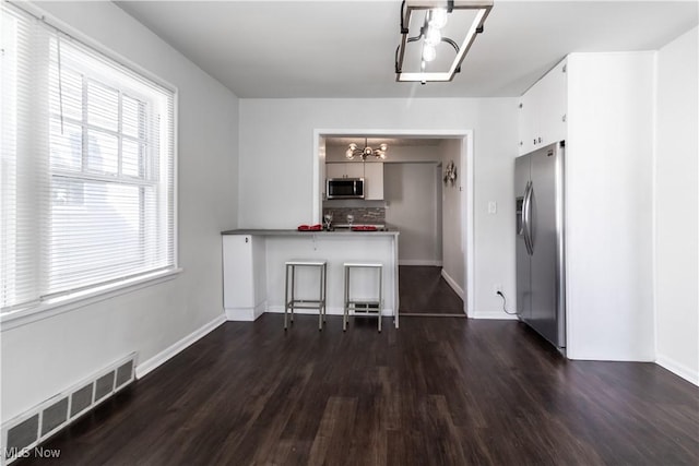 3525 Raymont Rd, University Heights, OH 44118 - kitchen featuring a chandelier, appliances with stainless steel finishes, dark wood-style floors, and healthy amount of natural light