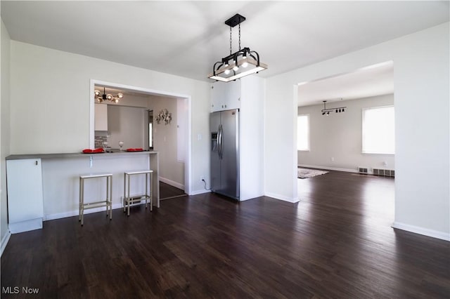3525 Raymont Rd, University Heights, OH 44118 - unfurnished dining area featuring a chandelier, dark wood finished floors, and baseboards