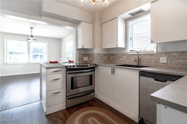 3525 Raymont Rd, University Heights, OH 44118 - kitchen with stainless steel appliances, a sink, dark wood-style flooring, white cabinets, and backsplash