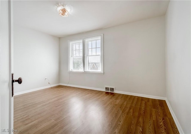 3525 Raymont Rd, University Heights, OH 44118 - empty room with wood finished floors and baseboards