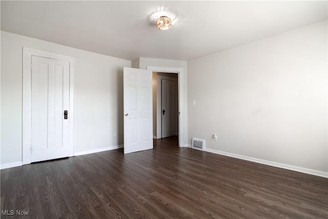 3525 Raymont Rd, University Heights, OH 44118 - unfurnished bedroom with dark wood-type flooring and baseboards