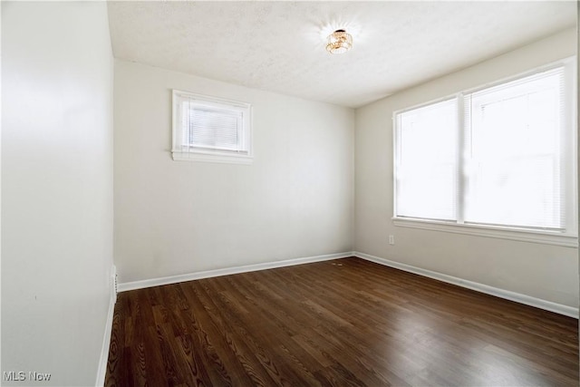 3525 Raymont Rd, University Heights, OH 44118 - empty room featuring baseboards and dark wood-type flooring