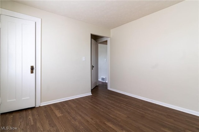 3525 Raymont Rd, University Heights, OH 44118 - unfurnished bedroom with dark wood finished floors and baseboards