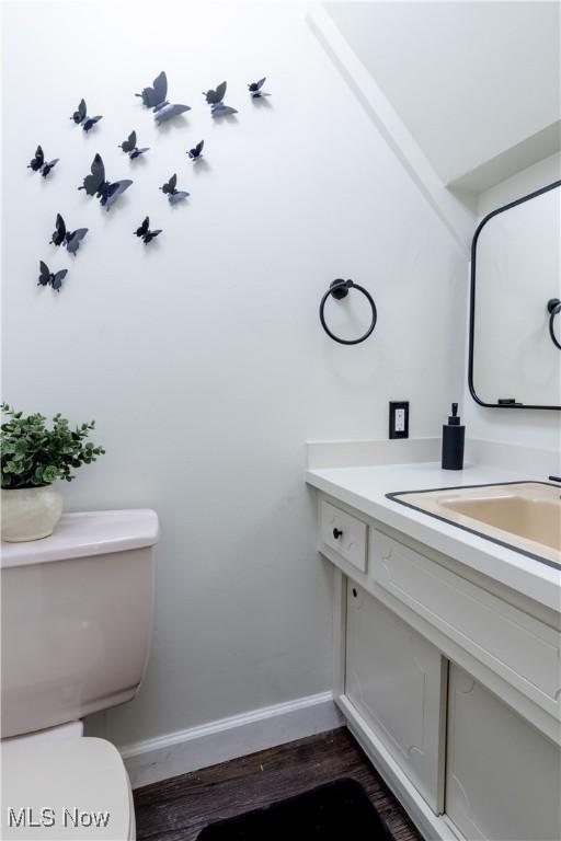 3525 Raymont Rd, University Heights, OH 44118 - half bath with baseboards, toilet, vanity, and wood finished floors