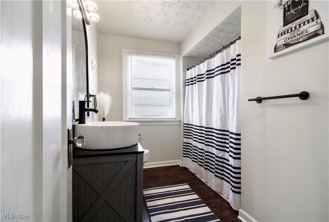 3525 Raymont Rd, University Heights, OH 44118 - bathroom featuring vanity, wood finished floors, baseboards, toilet, and a shower with curtain