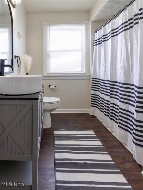 3525 Raymont Rd, University Heights, OH 44118 - bathroom with toilet, vanity, wood finished floors, and baseboards