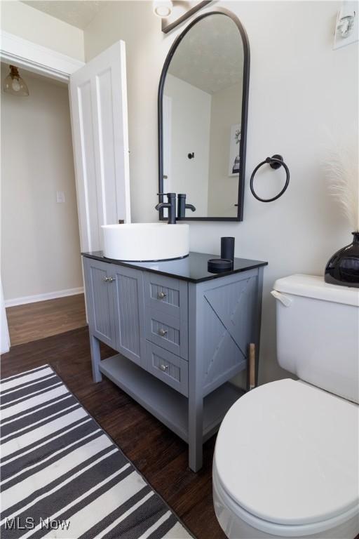 3525 Raymont Rd, University Heights, OH 44118 - bathroom with wood finished floors, vanity, toilet, and baseboards