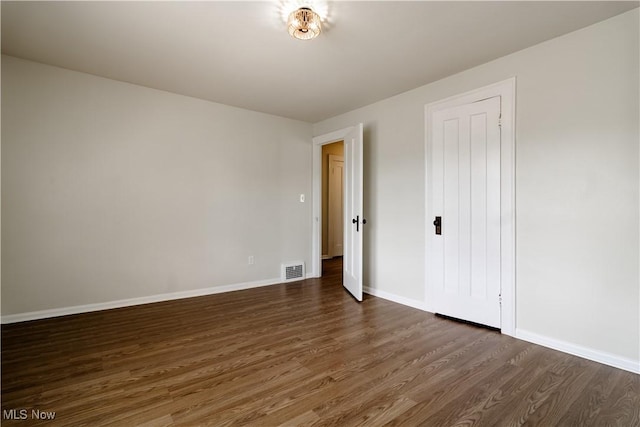 3525 Raymont Rd, University Heights, OH 44118 - unfurnished bedroom featuring dark wood-type flooring and baseboards
