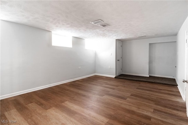 3525 Raymont Rd, University Heights, OH 44118 - basement featuring a textured ceiling, baseboards, and wood finished floors
