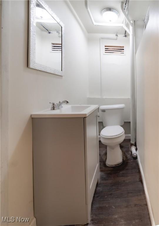 3525 Raymont Rd, University Heights, OH 44118 - bathroom featuring vanity, toilet, and wood finished floors