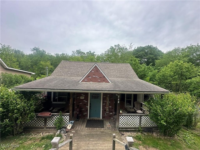 231 Pine St, Weirton, WV 26062 - view of front of house featuring covered porch, roof with shingles, and a view of trees