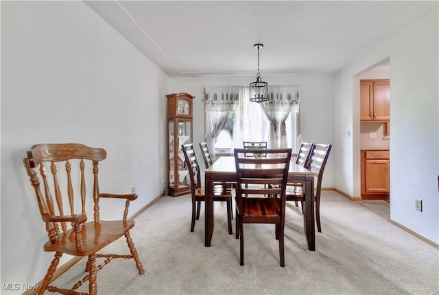 1922 W 38th St, Lorain, OH 44053 - dining room with light colored carpet, baseboards, and a chandelier