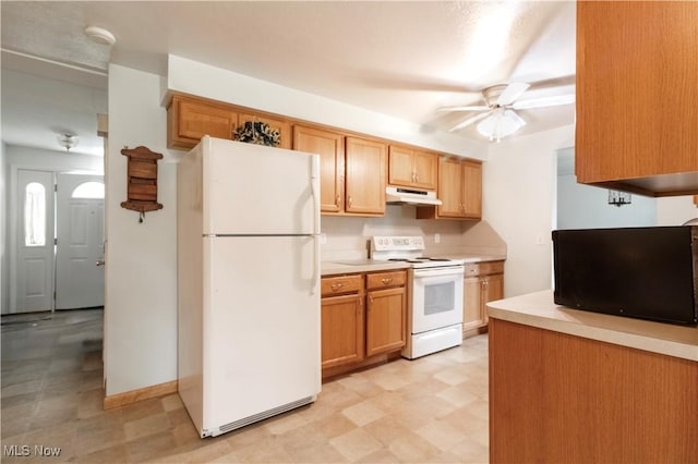 1922 W 38th St, Lorain, OH 44053 - kitchen with white appliances, under cabinet range hood, light flooring, ceiling fan, and light countertops