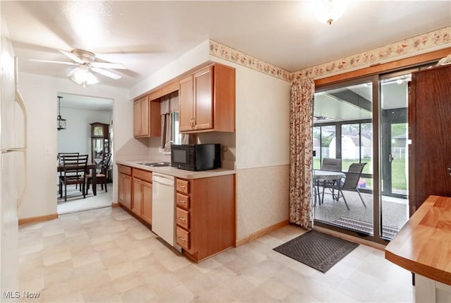 1922 W 38th St, Lorain, OH 44053 - kitchen featuring white appliances, light countertops, light floors, a ceiling fan, and a sink