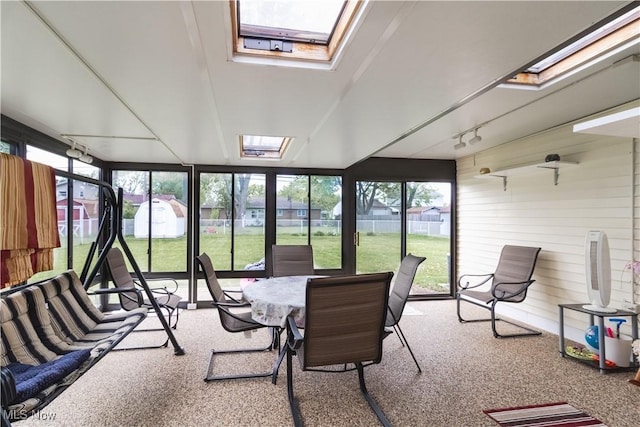 1922 W 38th St, Lorain, OH 44053 - sunroom featuring a skylight, carpet, expansive windows, and rail lighting
