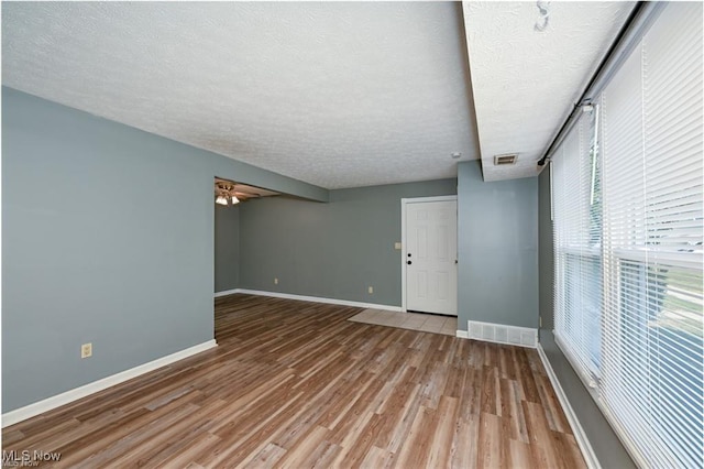 625 Canterbury Ln, Medina, OH 44256 - empty room with a textured ceiling, light wood finished floors, baseboards, and a ceiling fan