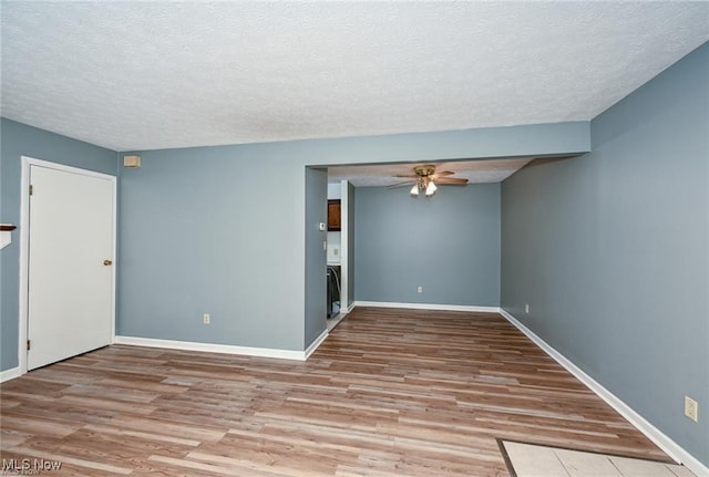 625 Canterbury Ln, Medina, OH 44256 - spare room with a textured ceiling, a ceiling fan, wood finished floors, and baseboards