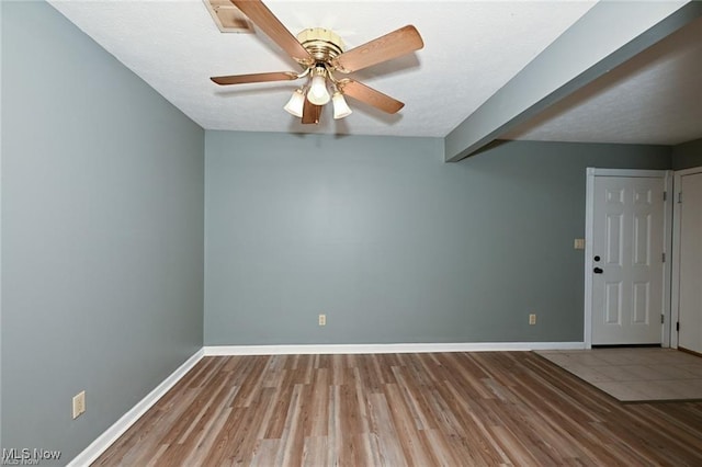 625 Canterbury Ln, Medina, OH 44256 - empty room with wood finished floors, baseboards, a ceiling fan, and a textured ceiling