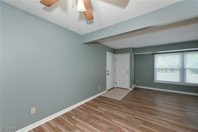 625 Canterbury Ln, Medina, OH 44256 - unfurnished room featuring wood finished floors, baseboards, a textured ceiling, and a ceiling fan