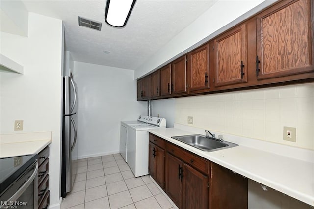 625 Canterbury Ln, Medina, OH 44256 - laundry room featuring light tile patterned flooring, independent washer and dryer, baseboards, and a textured ceiling