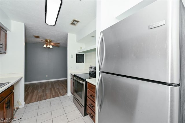 625 Canterbury Ln, Medina, OH 44256 - kitchen featuring appliances with stainless steel finishes, a ceiling fan, light countertops, light tile patterned floors, and a textured ceiling