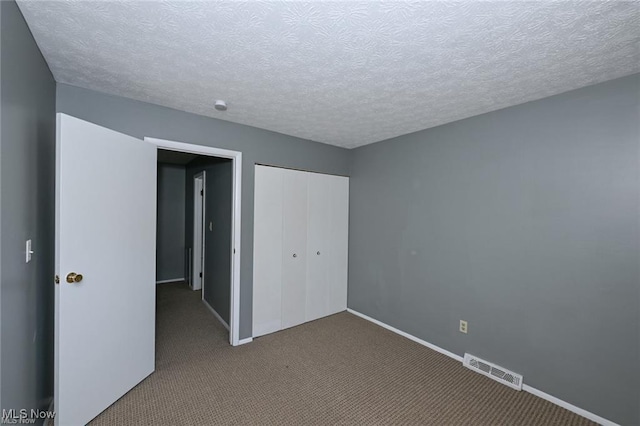 625 Canterbury Ln, Medina, OH 44256 - unfurnished bedroom with carpet, a closet, baseboards, and a textured ceiling