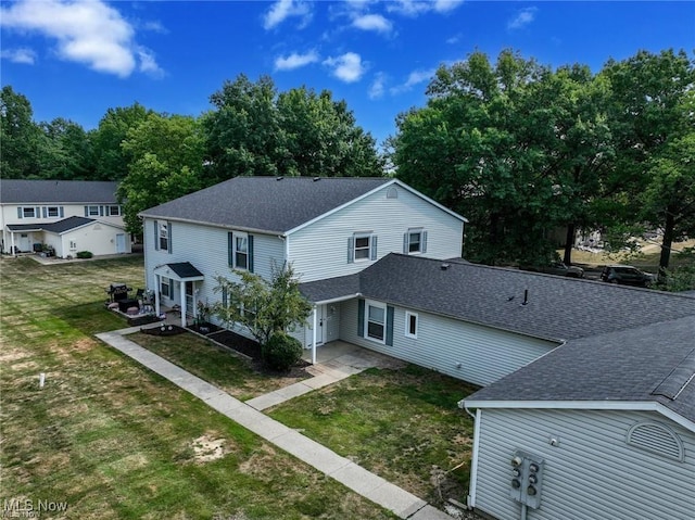 625 Canterbury Ln, Medina, OH 44256 - rear view of property with roof with shingles and a yard
