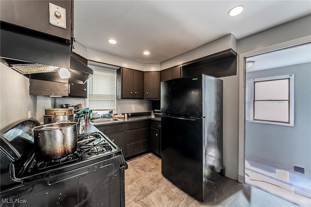5100 Greenhurst Dr, Maple Heights, OH 44137 - kitchen with black appliances, a sink, dark brown cabinetry, dark countertops, and recessed lighting