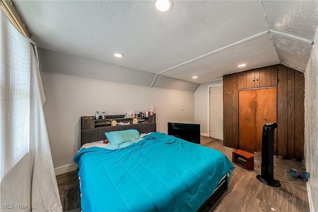 5100 Greenhurst Dr, Maple Heights, OH 44137 - bedroom featuring lofted ceiling, wood finished floors, baseboards, and a textured ceiling