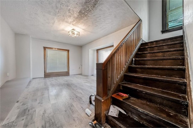5100 Greenhurst Dr, Maple Heights, OH 44137 - stairway featuring a textured ceiling and hardwood / wood-style floors