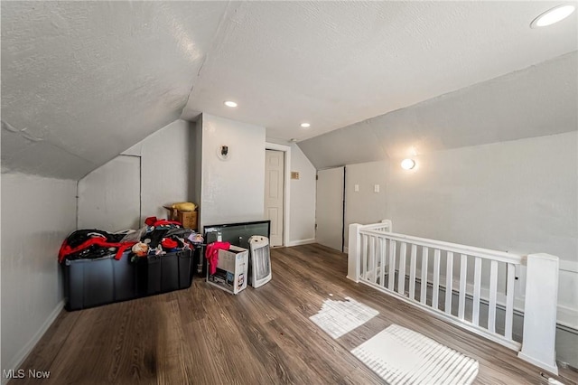 5100 Greenhurst Dr, Maple Heights, OH 44137 - additional living space with lofted ceiling, wood finished floors, a textured ceiling, and baseboards