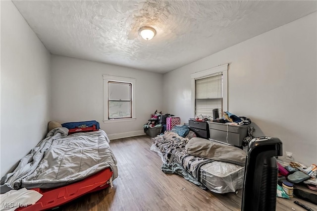 5100 Greenhurst Dr, Maple Heights, OH 44137 - bedroom with wood finished floors and a textured ceiling