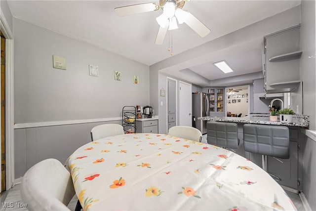 3573 Severn Rd, Cleveland Heights, OH 44118 - bedroom featuring freestanding refrigerator, wainscoting, and ceiling fan