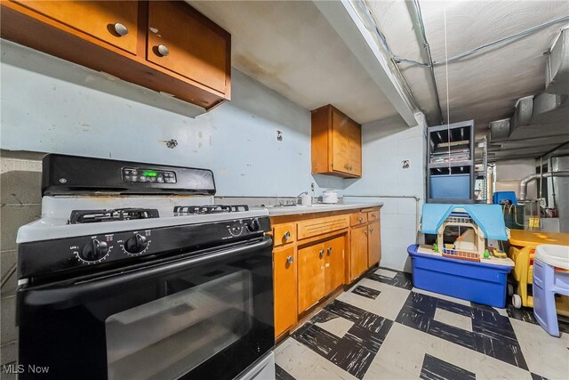 3573 Severn Rd, Cleveland Heights, OH 44118 - kitchen with black gas stove, tile patterned floors, light countertops, and brown cabinets