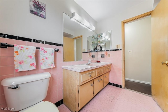 3573 Severn Rd, Cleveland Heights, OH 44118 - half bathroom featuring tile walls, toilet, vanity, and tile patterned floors