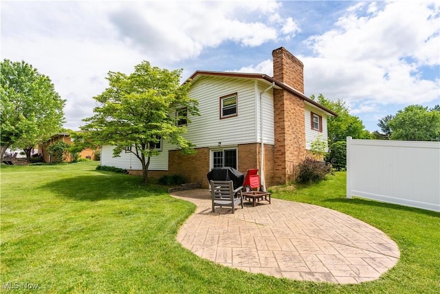 731 39th St SW, Canton, OH 44706 - rear view of property with a chimney, a patio, a lawn, and brick siding