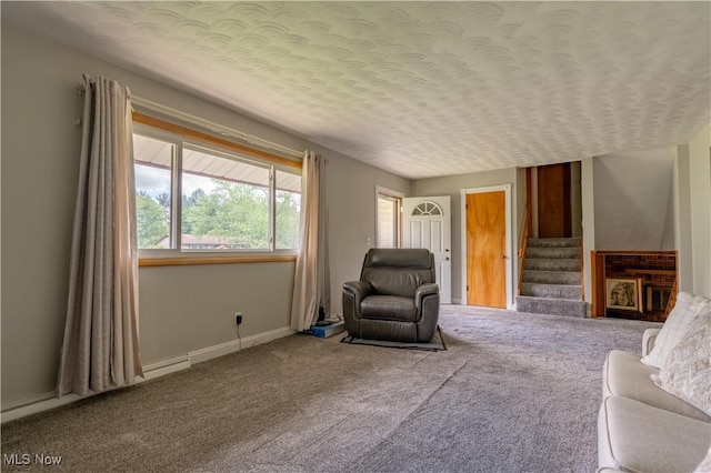 731 39th St SW, Canton, OH 44706 - carpeted living area with a textured ceiling, stairs, and baseboards