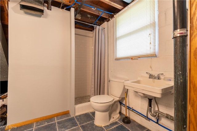 731 39th St SW, Canton, OH 44706 - bathroom featuring toilet, a stall shower, tile patterned floors, and a sink