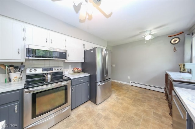12274 Kile Rd, Chardon, OH 44024 - kitchen with appliances with stainless steel finishes, a baseboard heating unit, ceiling fan, and white cabinetry